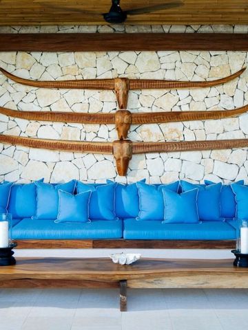 Stilvolle Lounge mit blauen Sofas und dekorativer Wand