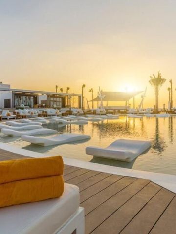 Luxuriöser Poolbereich bei Sonnenuntergang mit bequemen Liegen