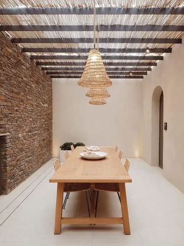 Speisesaal mit rustikalem Steintisch und hängender Lampe