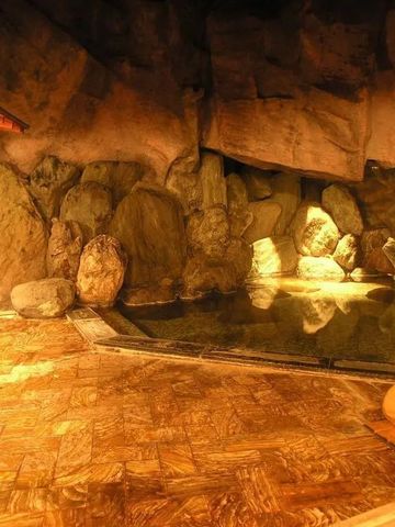 Warmes Licht über einem felsigen Innenbad mit heißem Wasser