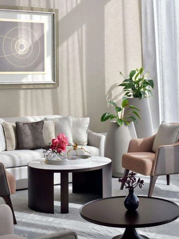 Elegantes Wohnzimmer in neutralen Tönen mit modernen Möbeln und Kunstwerk.