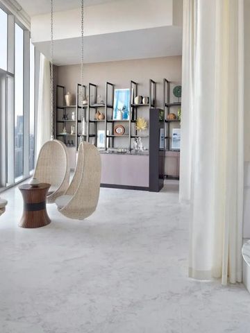 Helles Zimmer mit hängenden Korbsesseln und Stadtblick in modernem Design.