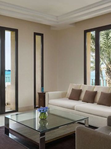 Eleganter Wohnbereich mit Glasfront und Ausblick auf den Balkon