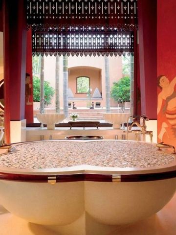Großes Badezimmer mit dekorativer Badewanne und stilvollen Rotakzenten