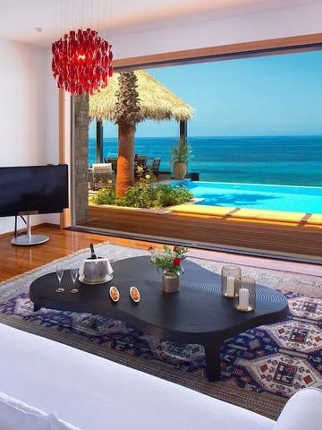 Helles Wohnzimmer mit großem Fensterblick auf Pool und Meer
