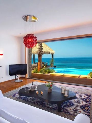Wohnbereich mit Panoramafenster und Blick auf Meer und Terrasse
