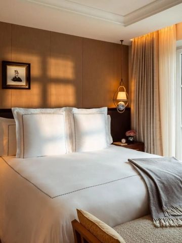 Gemütliches Zimmer mit Doppelbett, eleganten Leuchten und Balkonaussicht