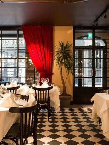 Elegantes Restaurant mit gedeckten Tischen und rotem Vorhang
