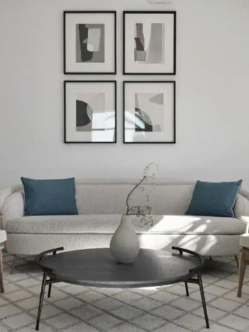 Gemütlicher Wohnbereich mit Sofa, Kissen und modernem Couchtisch