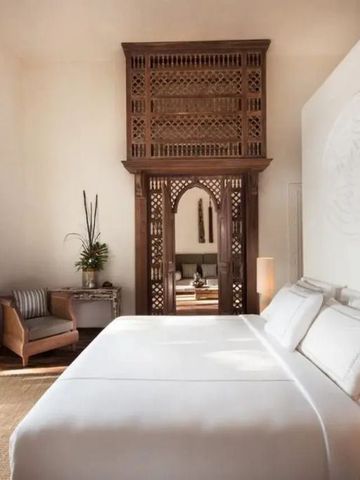Bedroom with elaborate wood detailing and a large window