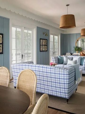 Elegantes Wohnzimmer mit blauen Sofas und stilvoller Beleuchtung
