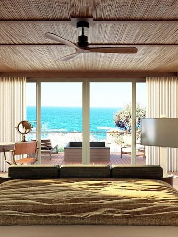 Schlafzimmer einer Suite mit Meerblick und modernem Design