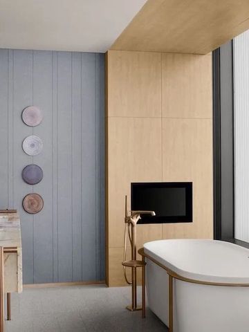 Luxuriöses Badezimmer mit freistehender Badewanne und Stadtblick