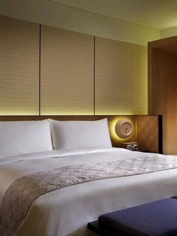 Bequemes King-Size-Bett in einem stilvollen Hotelzimmer.