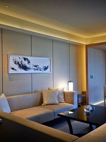 Elegant eingerichtetes Wohnzimmer in einer Suite mit moderner Kunst an der Wand