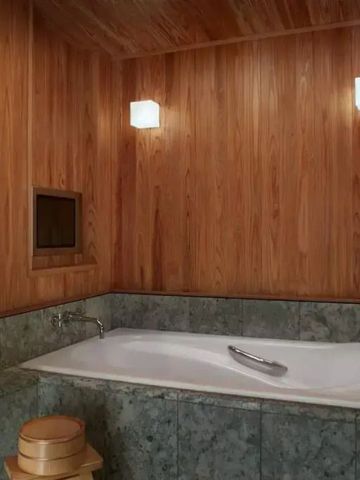 Holzverkleidetes Badezimmer mit großer Badewanne