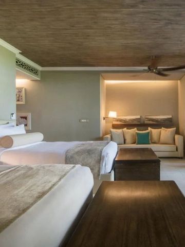 Elegantes Hotelzimmer mit zwei Betten und gemütlicher Sitzecke
