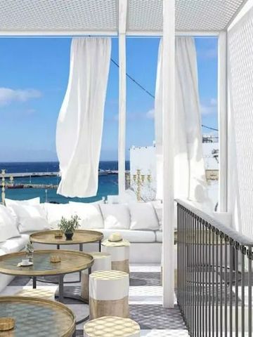 Lounge-Bereich mit Meerblick und weißen Sofas im The TownHouse Mykonos
