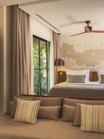 Modernes Hotelzimmer mit großem Bett und gemütlicher Sitzecke