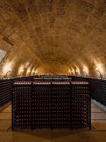 Stimmungsvoller Weinkeller mit Flaschenregalen in gewölbtem Raum