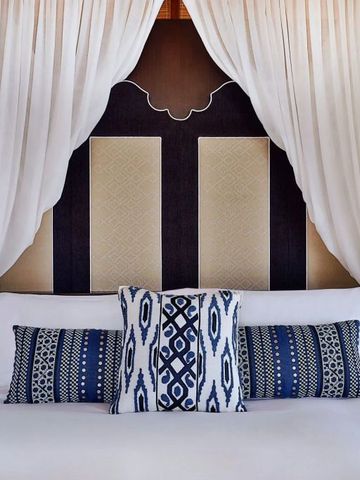 Detailansicht eines stilvollen Himmelbetts mit gemusterten Kissen im Ritz-Carlton