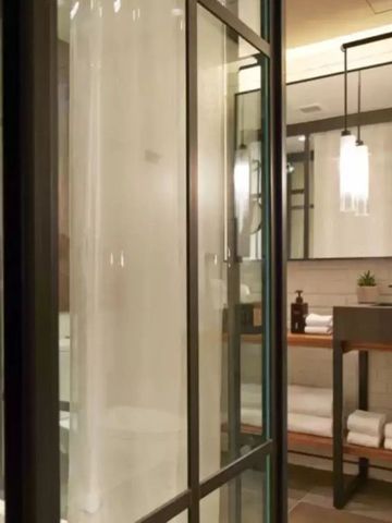 Modernes Badezimmer mit Dusche und Waschbecken im industriellen Stil.