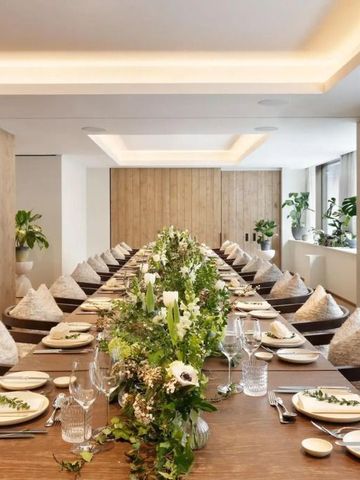 Luxuriös gedeckter Tisch in einem hellen Restaurant mit Pflanzen