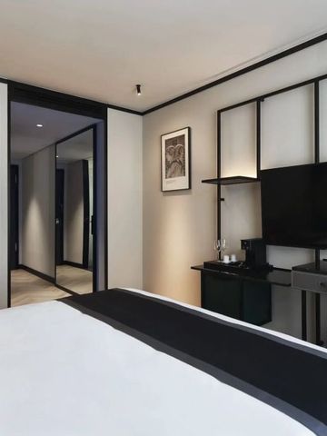 Modern eingerichtetes Hotelzimmer mit Schreibtisch und Flachbildfernseher