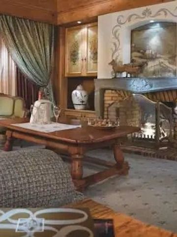 Gemütlicher Wohnbereich mit Kamin und stilvoller Einrichtung im Chalet-Stil