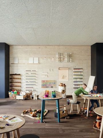 Kinderbereich mit Bastelmaterialien und spielenden Kindern