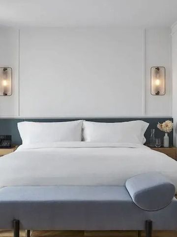 Elegantes Hotelzimmer mit großem Doppelbett und minimalistischer Einrichtung
