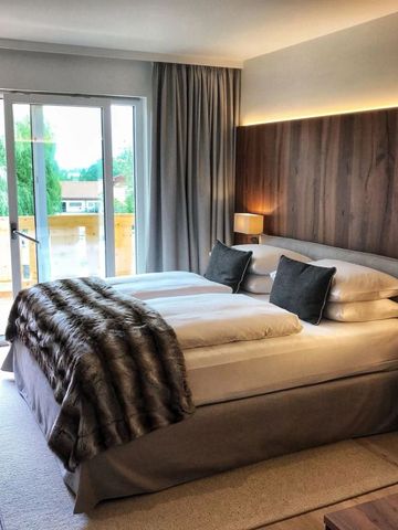 Gemütliches Hotelzimmer mit Doppelbett und Holzakzenten