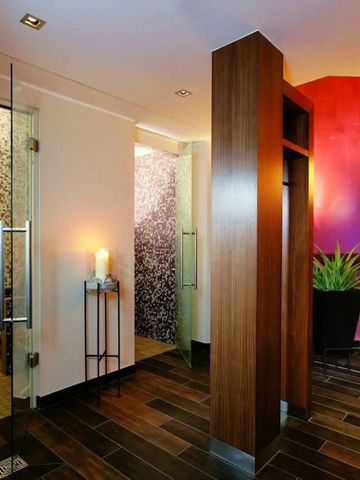 Moderne Sauna mit warmem Holz und gläsernen Elementen