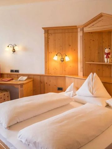 Doppelbett mit Holzverkleidung und Schreibtisch.