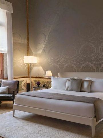 Geräumiges Schlafzimmer mit stilvollem Dekor und großen Fenstern