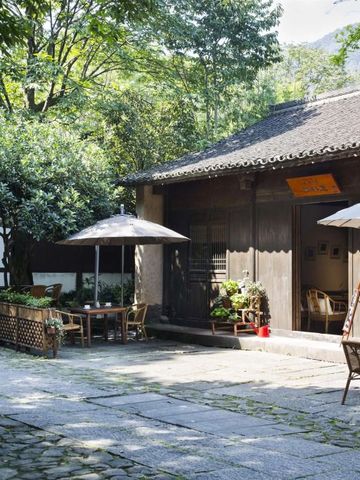 Außenbereich eines traditionellen Gebäudes mit Garten und Sitzmöglichkeiten