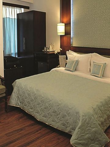 Gemütliches Hotelzimmer mit großem Bett und eleganter Einrichtung