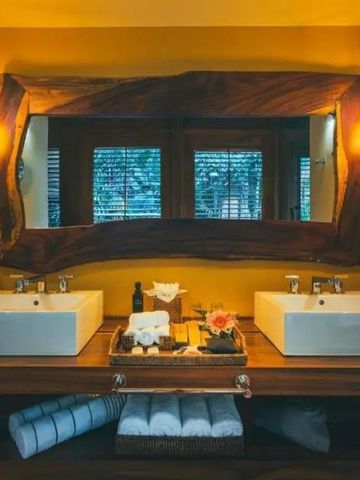 Stilvolles Badezimmer mit Doppelwaschbecken und großem Holzspiegel