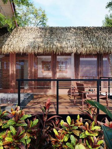 Villa mit Strohdach und privater Terrasse umgeben von tropischen Pflanzen