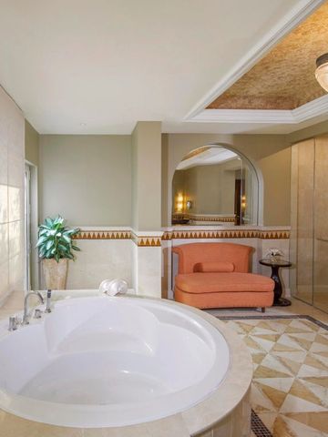 Luxuriöses Badezimmer mit großer runder Badewanne und eleganter Beleuchtung