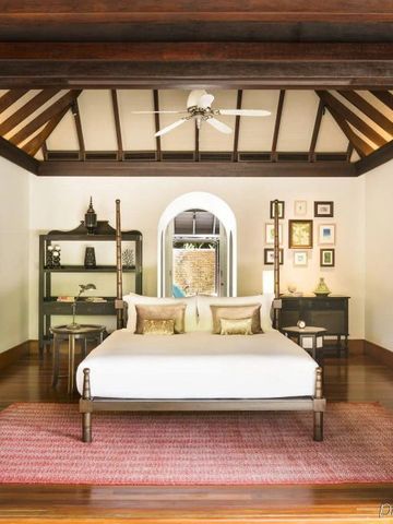 Luxuriöses Schlafzimmer mit Holzdekor und offenem Blick in den Garten