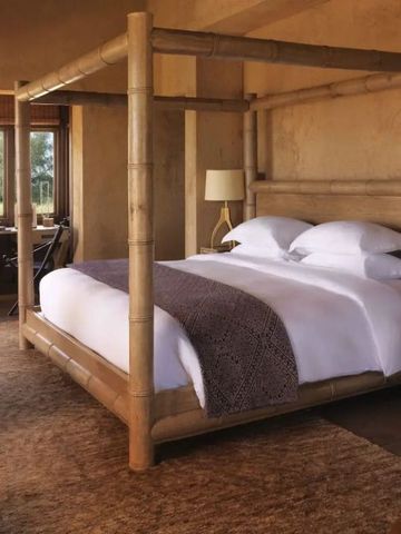 Rustikales Schlafzimmer mit Himmelbett und gemütlicher Einrichtung im Resort