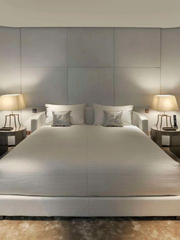 Modern eingerichtetes Schlafzimmer mit Nachttischlampen und komfortablem Bett