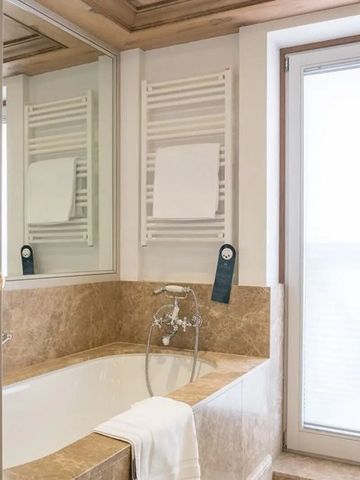 Helles Badezimmer mit Badewanne und weißen Handtüchern