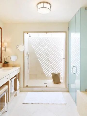 Modernes helles Badezimmer mit großer Dusche und stilvollem Waschbereich.