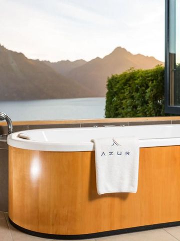 Freistehende Badewanne mit Aussicht auf Berge bei Sonnenuntergang