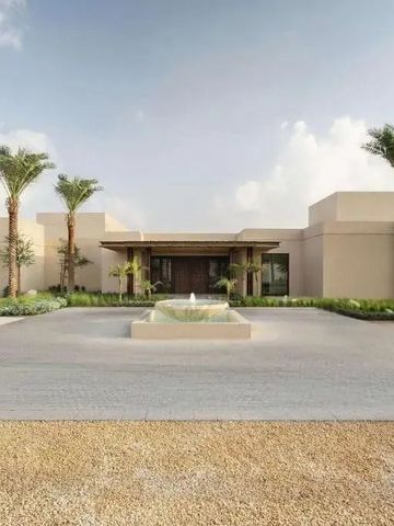 Fassade des Bab Al Shams Hotels mit Palmen und Brunnen