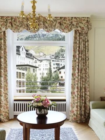 Salon mit Blumendekor und Blick auf die umliegenden Gebäude.