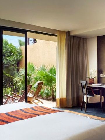 Helles Zimmer mit Blick auf den tropischen Garten, Terrassenzugang und eleganter Einrichtung