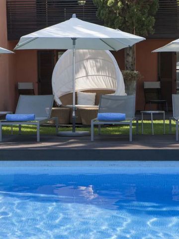 Sonnenliegen und Sonnenschirme am Pool